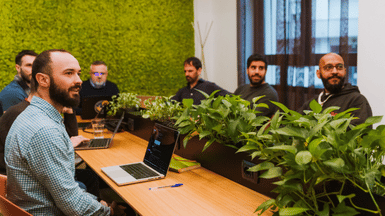 People in a office with plants having a meeting